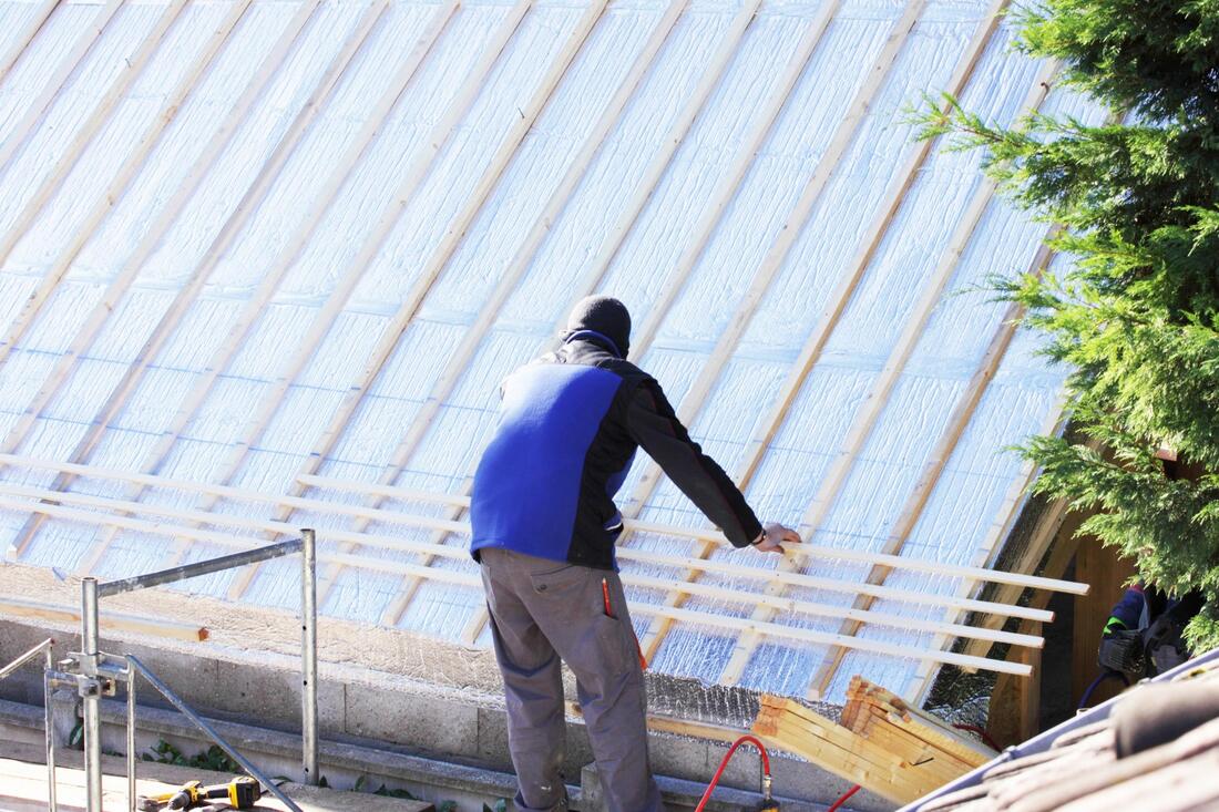 construction worker installing roof